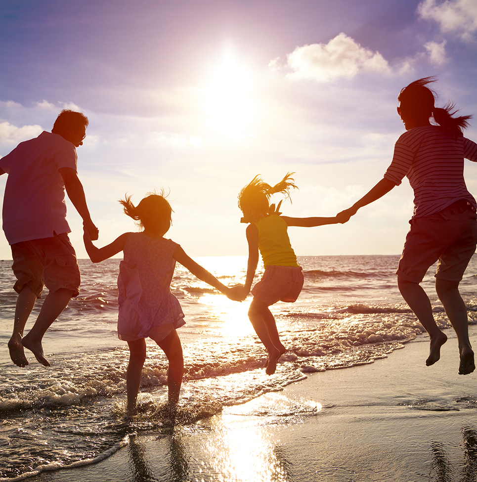  Family jumping for joy, creating incredible memories on vacation at the beach thanks to GCI